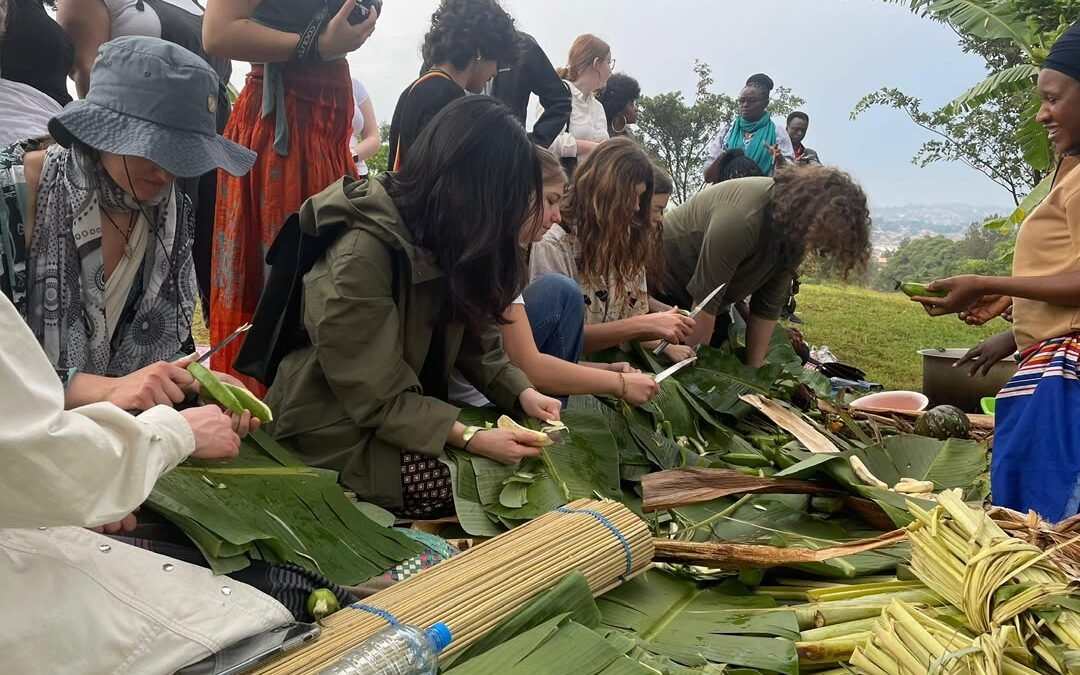 Tourists learning how to prepare matooke