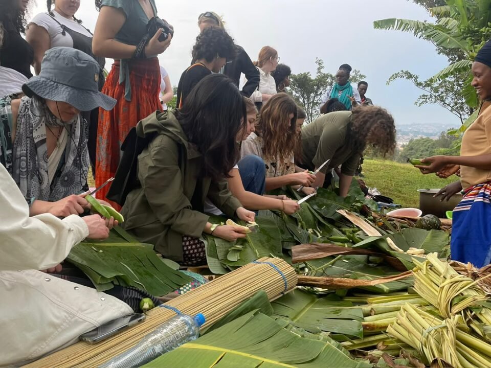 Tourists learning how to prepare matooke