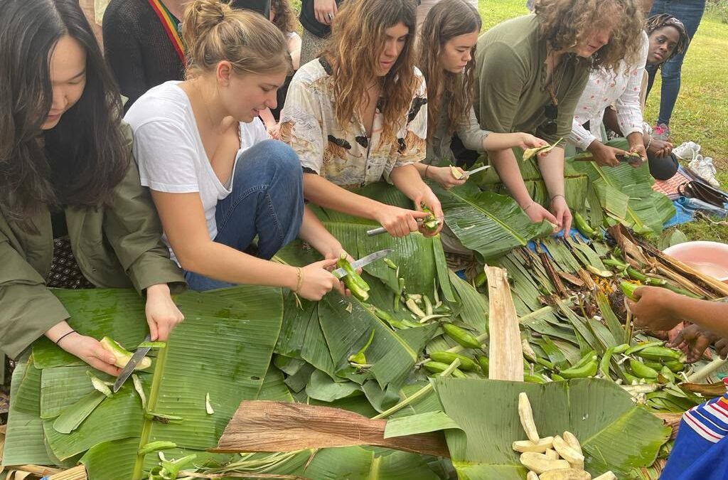 Visitors peeling matooke