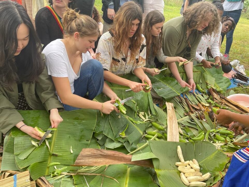 Visitors peeling matooke